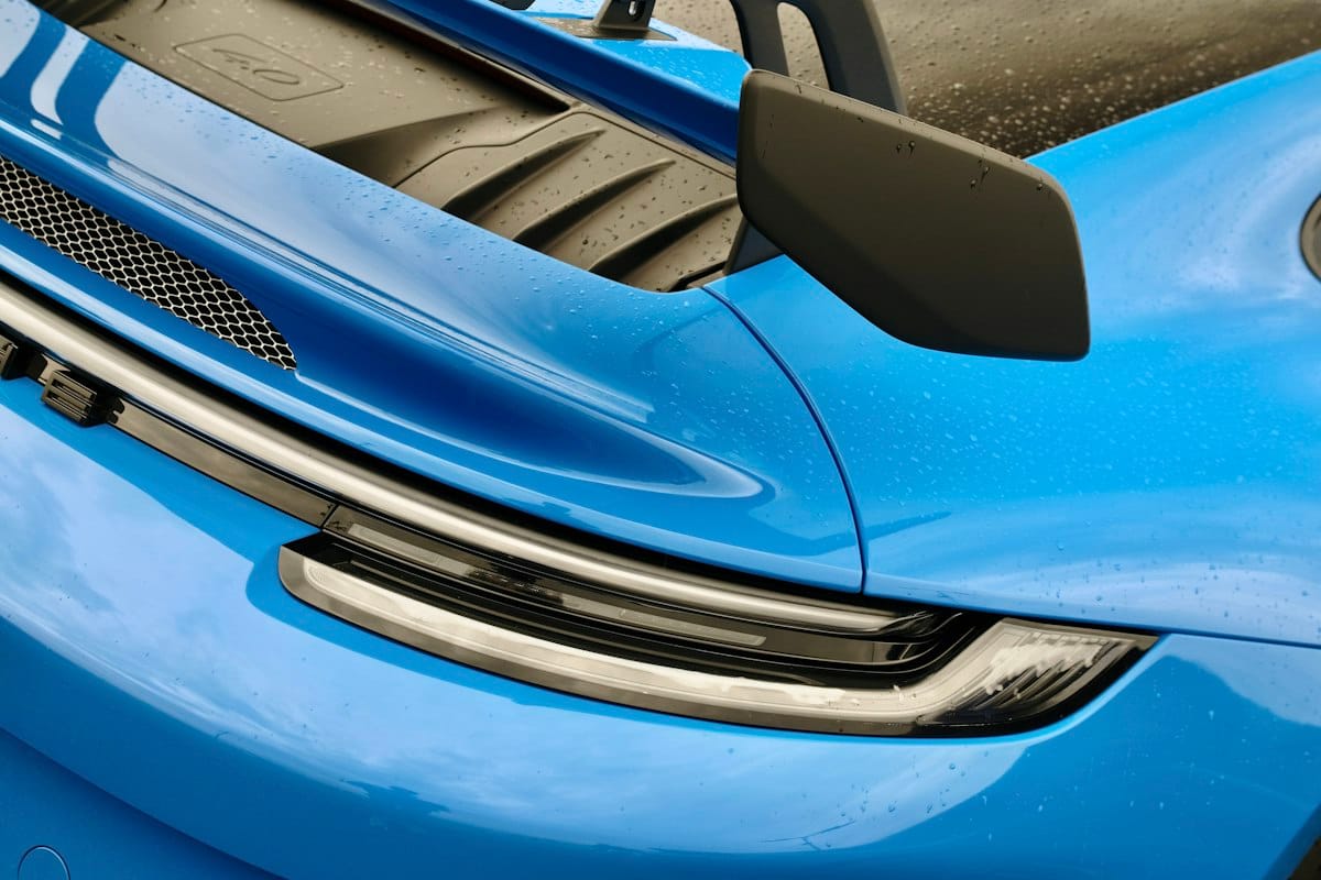Close-up of a blue sports car's headlight